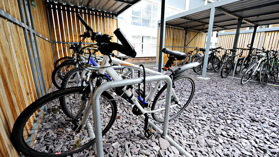 Photo of bikes in sheltered bike rack on campus