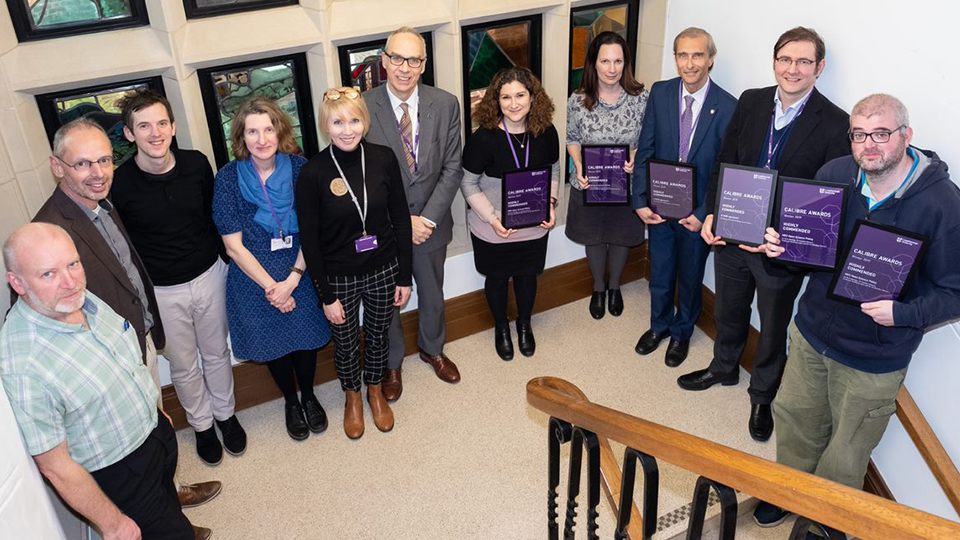 Photos of the all the CALIBRE Award finalists and winners for Winter 2019 stood together on staircase with Professor Steve Rothberg