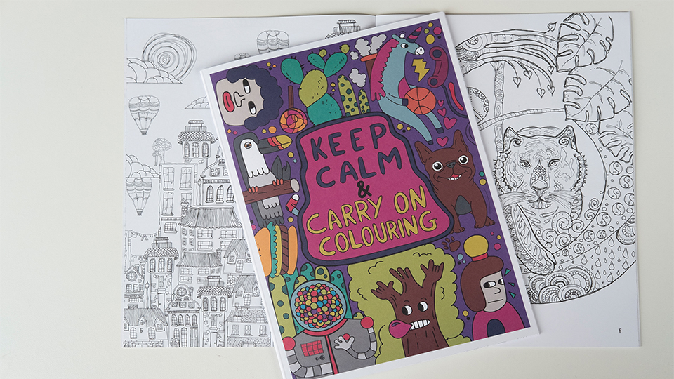 photo of the colouring book with the cover and also an example of one of the drawings inside the book