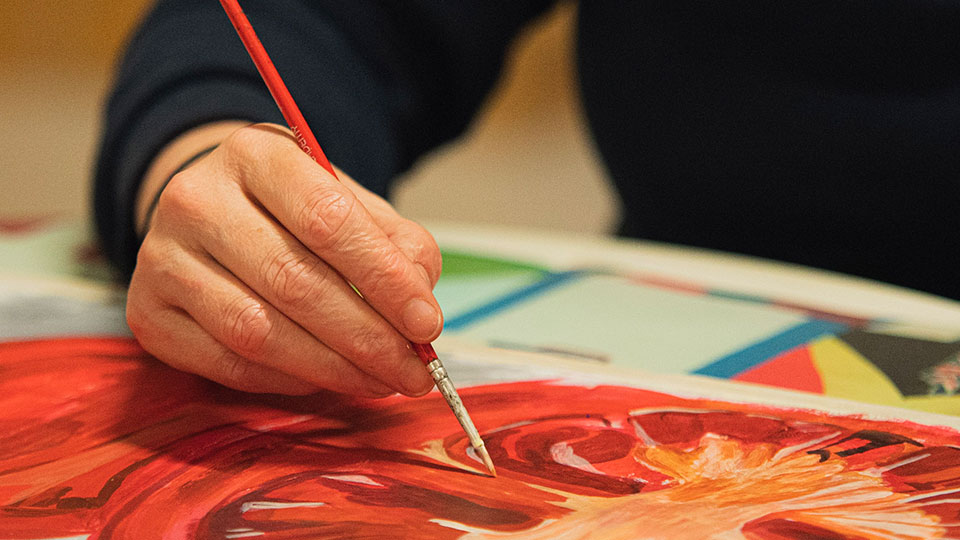 A person painting at LU Arts' evening classes