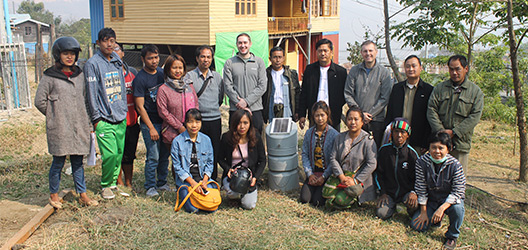 Pictured is Professor Neil Dixon and Dr Alister Smith, of the School of Architecture, Building and Civil Engineering, staff from the project funders FHI360 and the local partner Chin Committee for Emergency Response and Rehabilitation (CCERR) with some of their youth volunteers. Also pictured is Minister of Social Affairs for Chin State Pu Pau Lun Min Thang.
