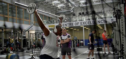 photo of Dillian Whyte training with weights at Powerbase gym