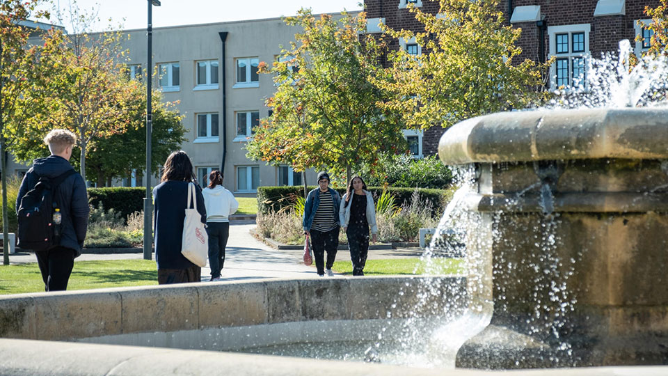 People walking by Hazlerigg fountain