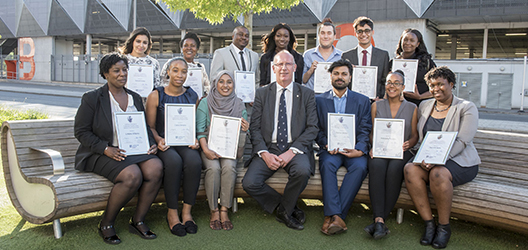 photo of VC Bob with graduates of the Inspiring Success programme at the LU London campus holding certificates