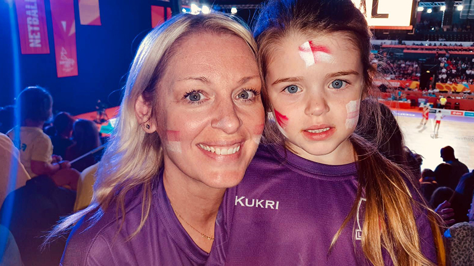 Photo of Kate Wigham with her daughter in the stands at the Netball semi-final in Birmingham