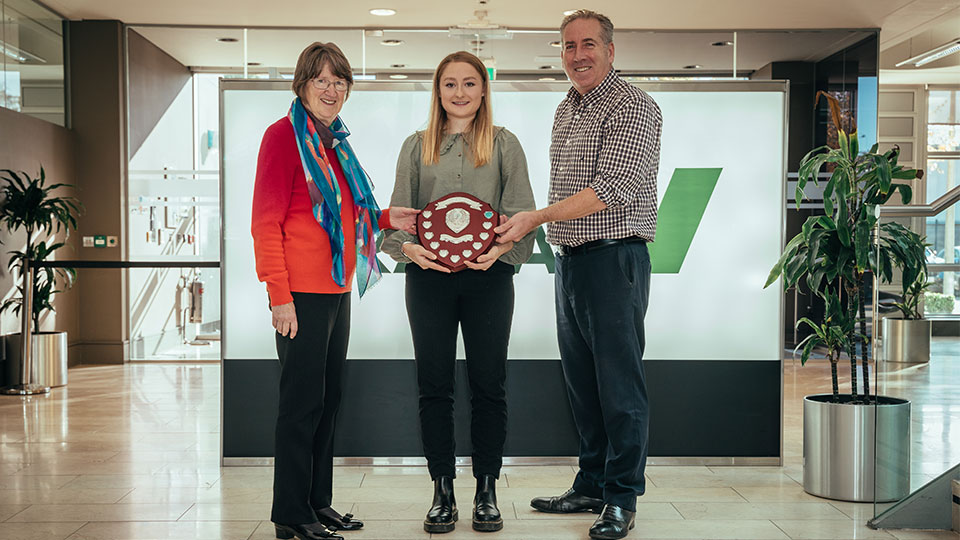 Lauren Vavasour receiving an award from two colleagues