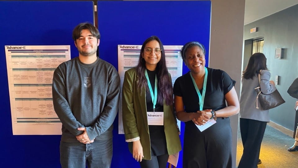 Lewis Jenkins stood outside an AdvanceHE conference with his colleagues Tandrima and Denise.