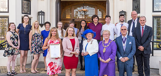 Action receiving the Queen's Award outside of the Hazlerigg building