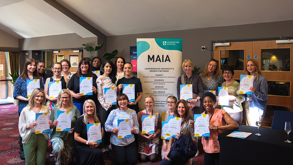 Women standing with certificates