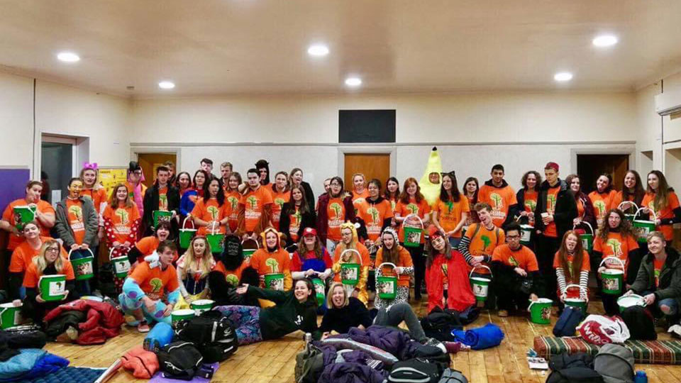 Large group of students with collection buckets