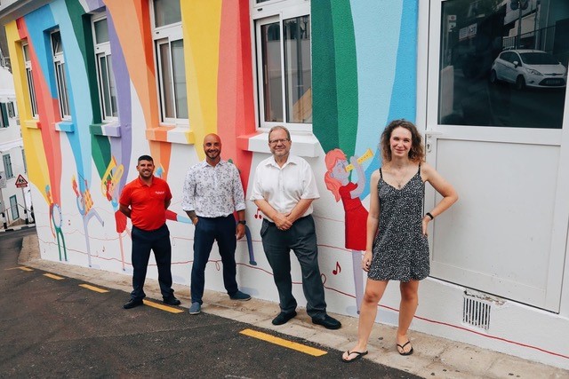 Monica Popham in front of her mural