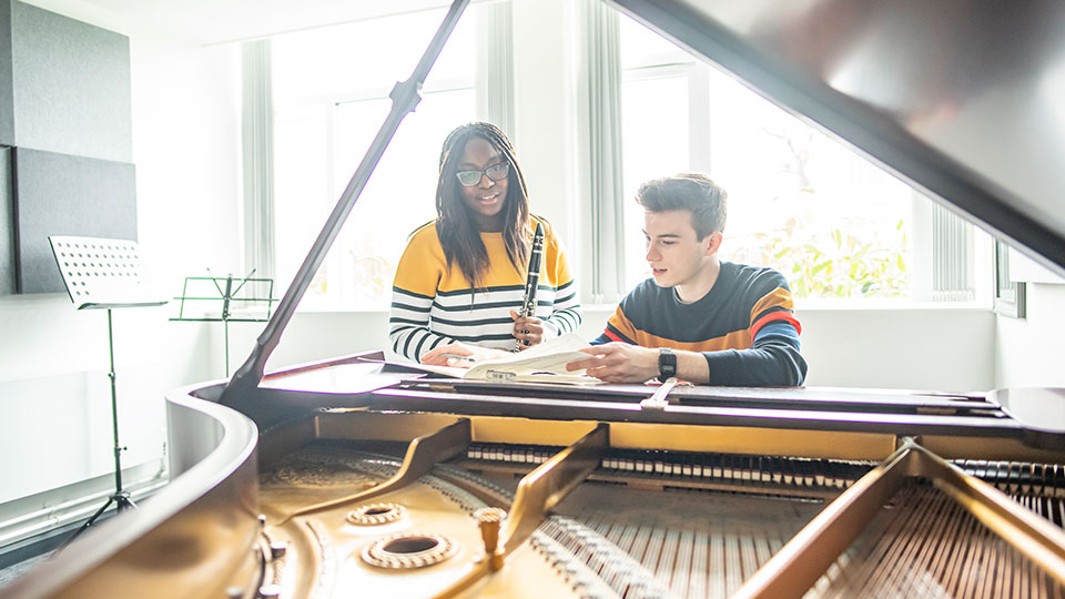 Two people at a piano