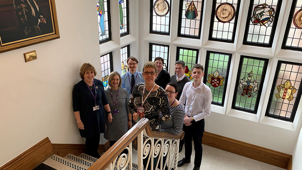 Photo of Payroll and Pensions team on staircase