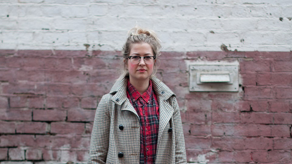 Person standing in front of a wall