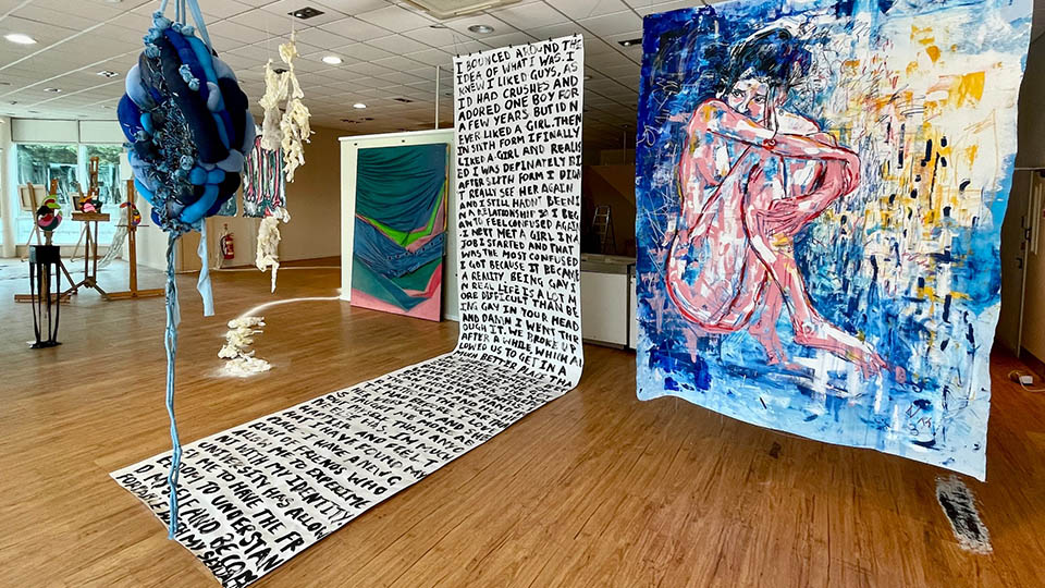 Photo of the empty shop unit in The Rushes Shopping Centre with pieces of artwork on display which has been created by second-year fine art students