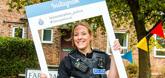 PC Charlotte Dickens with Instagram sign outside university hall of residence