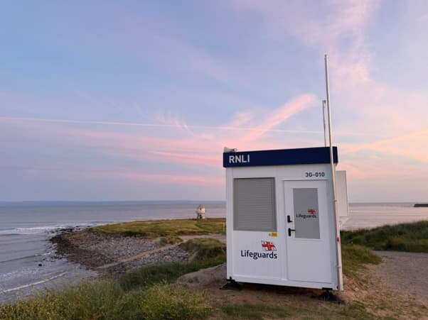 One of the new base units on the beach with a sunset in the background