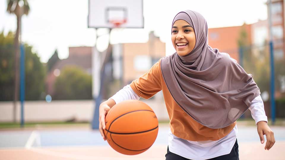 A person playing basketball in a playground