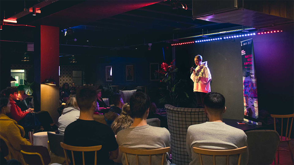 Image of student on stage in front of audience