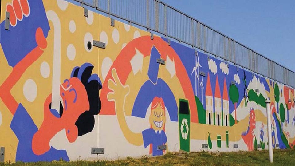 A colourful painted mural of illustrated people and sustainability symbols on a wall.