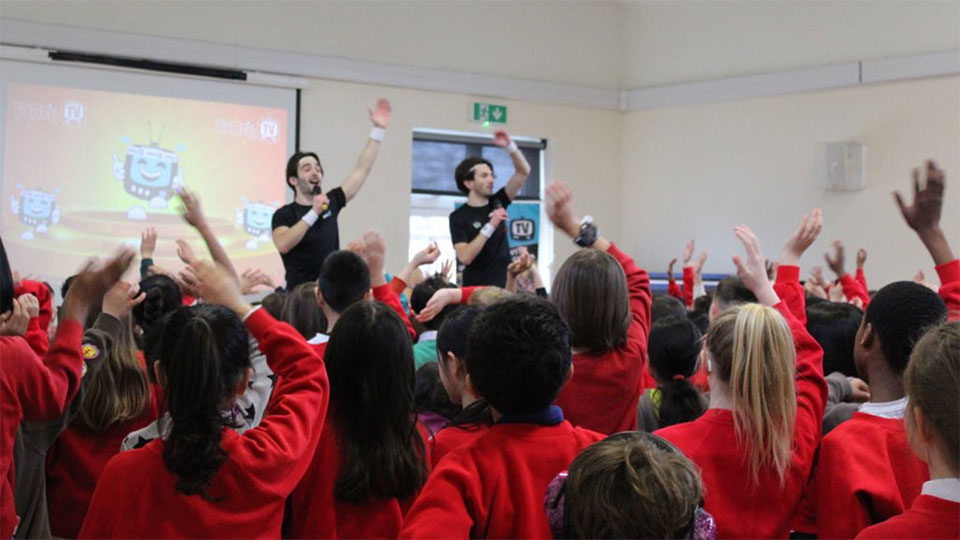 Two men teaching PE to primary school children