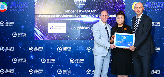 Photo of Simon and Charlie accepting the University's award at the ceremony