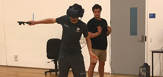 Photo of a student from Loughborough testing out VR technology at Victoria University 