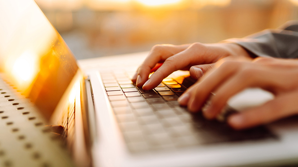 hands typing on a keyboard