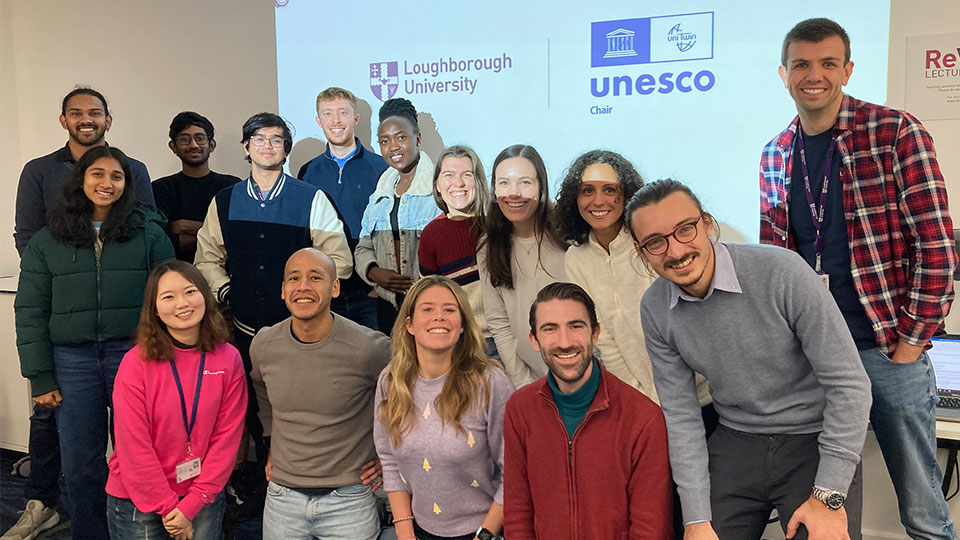 UNESCO Student Network members stood in front of a screen