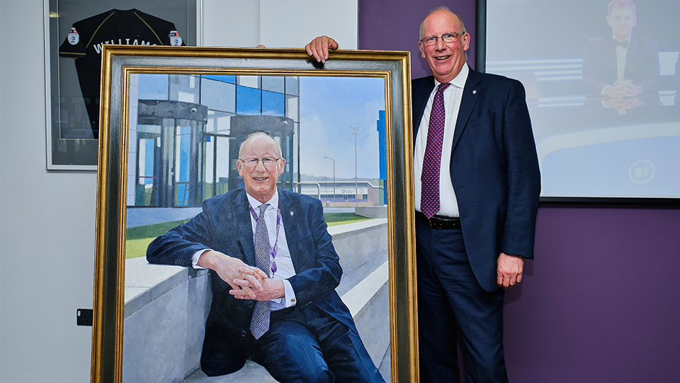 VC Bob stood next to his portrait by painter Paul Brason