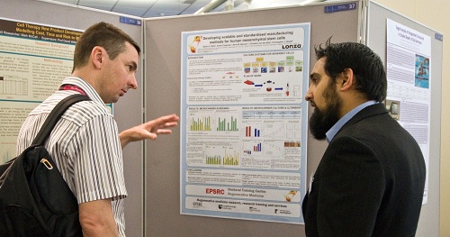 Qasim Rafiq discussing his research poster with Dr Richard Ferguson