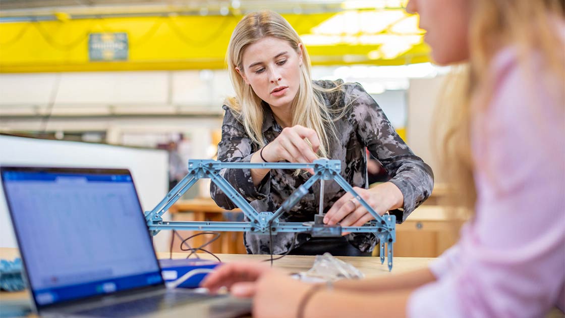 Students working on model of bridge