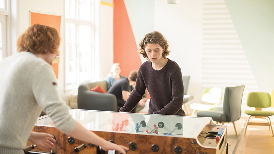 Students playing table football in halls of residence